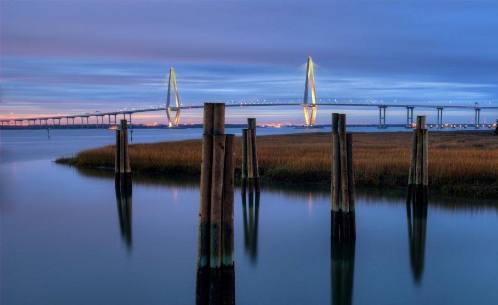 Cooper River Veterans Park at night with a large bridge in the background in Charleston, SC