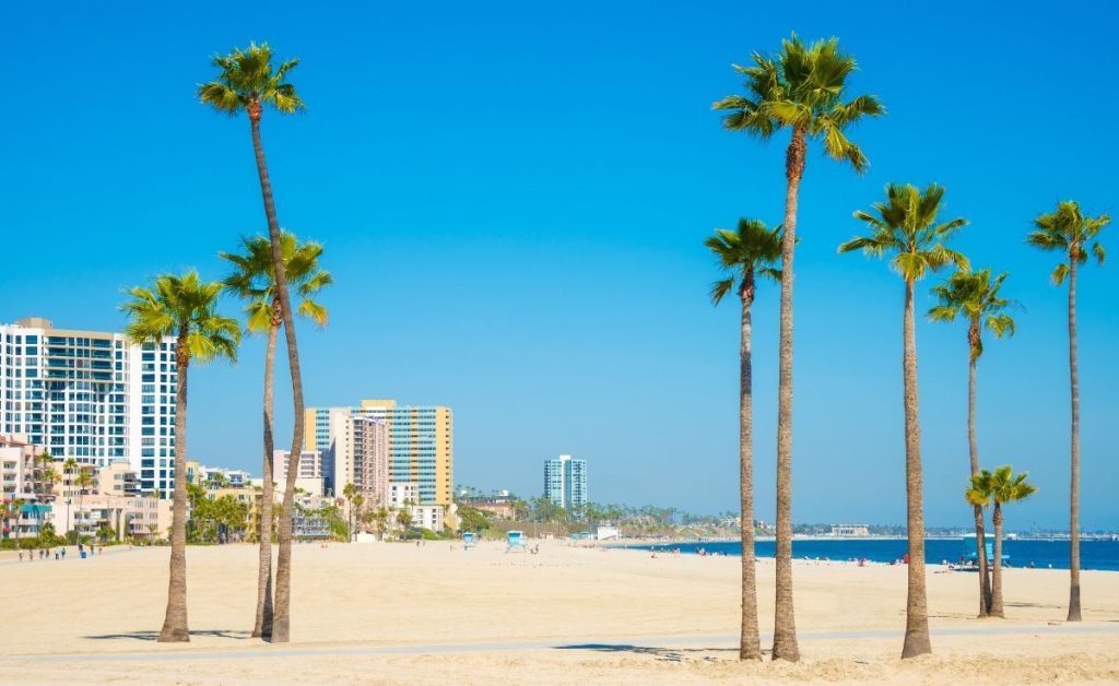 Long Beach on a sunny day with blue skies and golden sand, an example of what you can see on California trips 