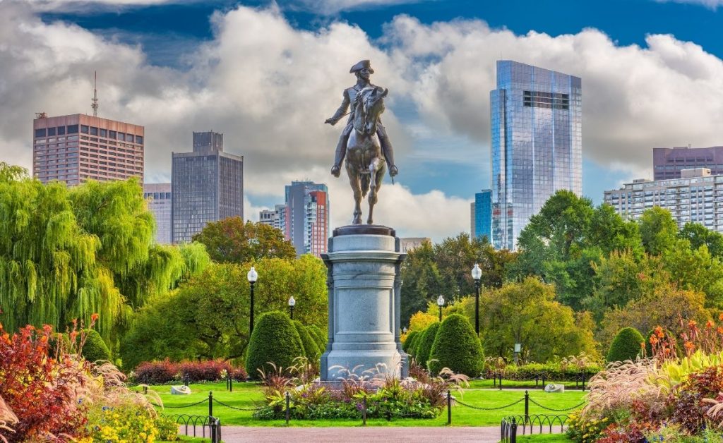 a historical landmark and statue in a Boston park, an example of what you can see during Boston trips