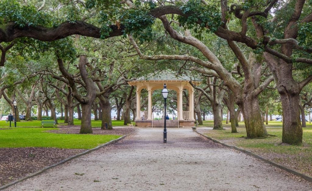 White point garden one of the best charleston south carolina attractions with overhanging trees and a white pergola