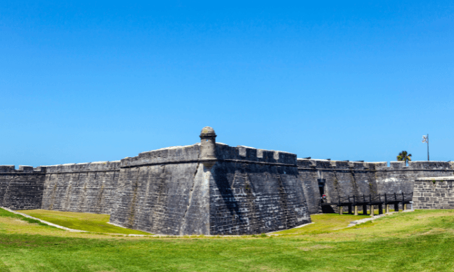 View of the Castillo De San Marcos Fort with blue skies and green grass