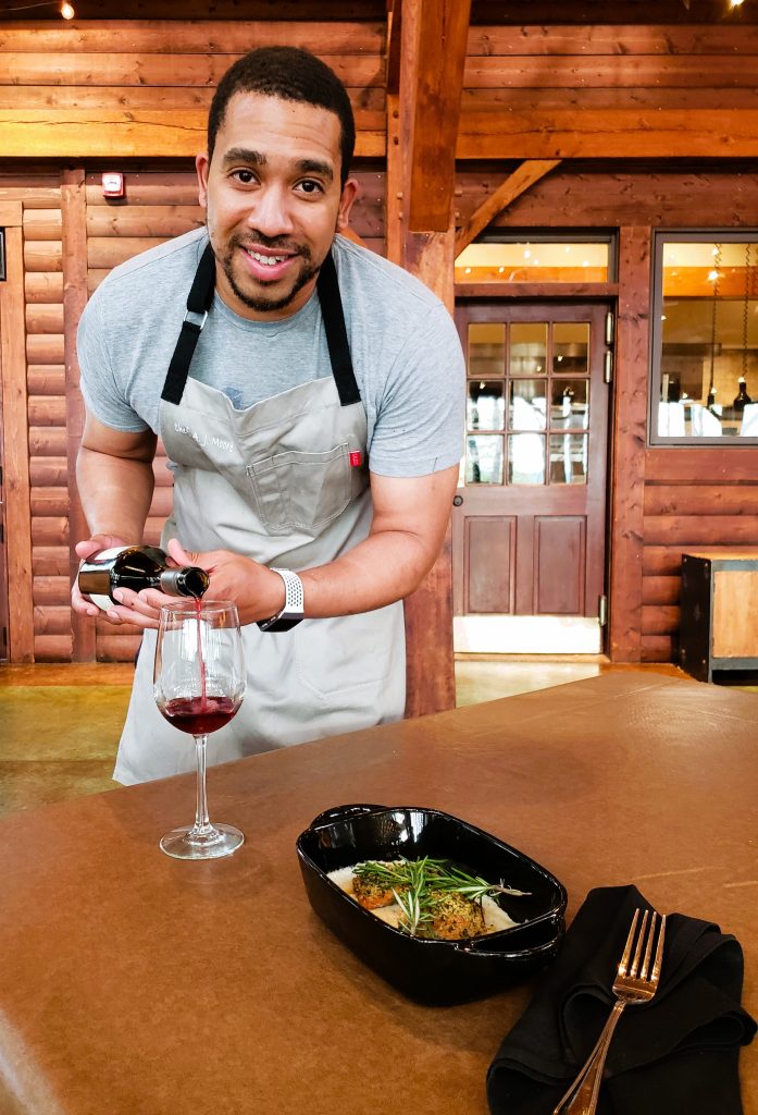  Chef AJ serves wine to compliment the Black Walnut Crusted Trout and Boursin Grits © Jo Clark