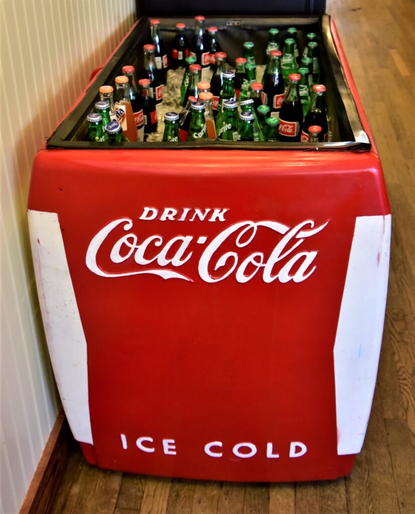Large floor style Coca-Cola drink box filled with ice and bottle drinks.