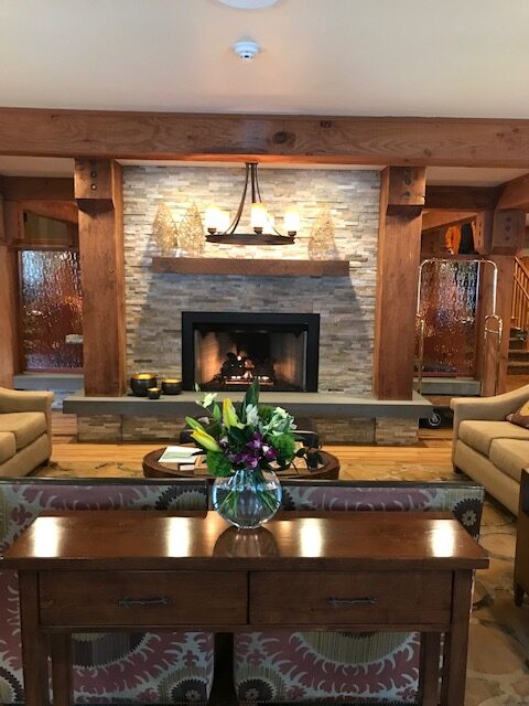 Stone fireplace in the lobby of the Stephanie Inn, surrounded by couches