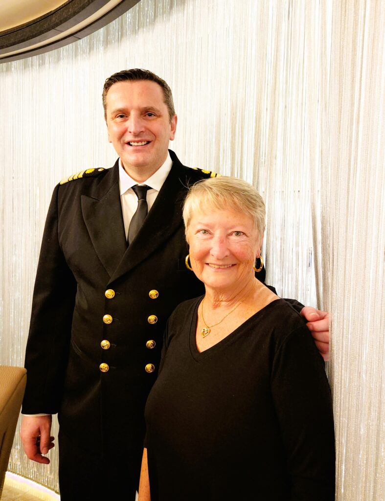 Ship Captain and the writer in front of the beaded privacy curtain