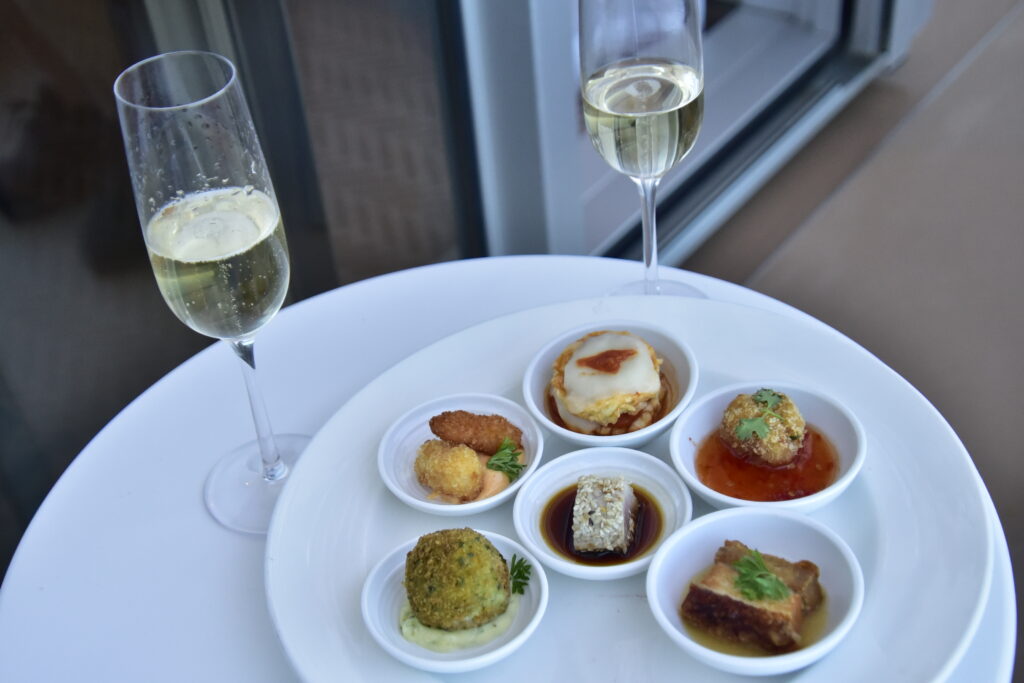 Sushi and other delicacies on a tray on the cabin's balcony