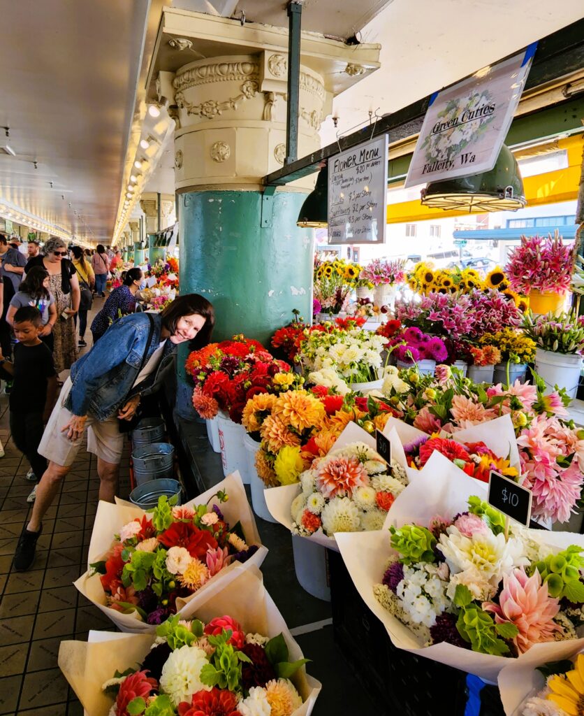 Woman smelling the fresh flowers in a market filled with flowers
