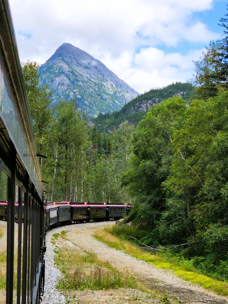 View of the front of our train rounding a curve with mountains in background