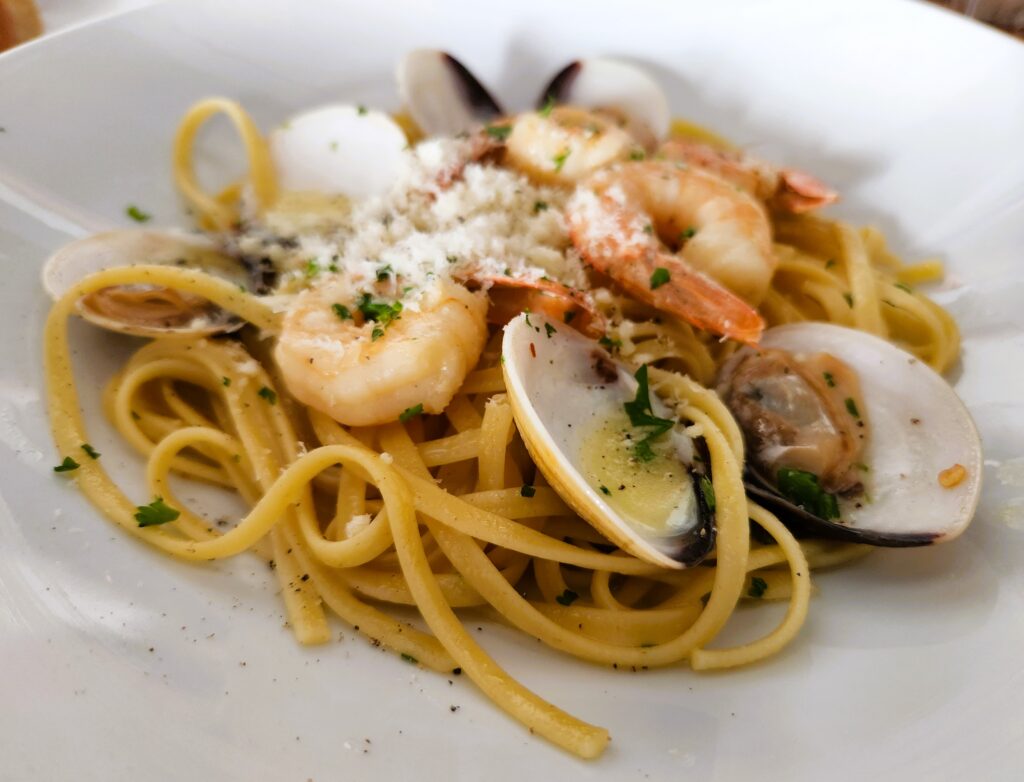 Linguini topped with clams and shrimp, sprinkled with freshly grated parmesean cheese