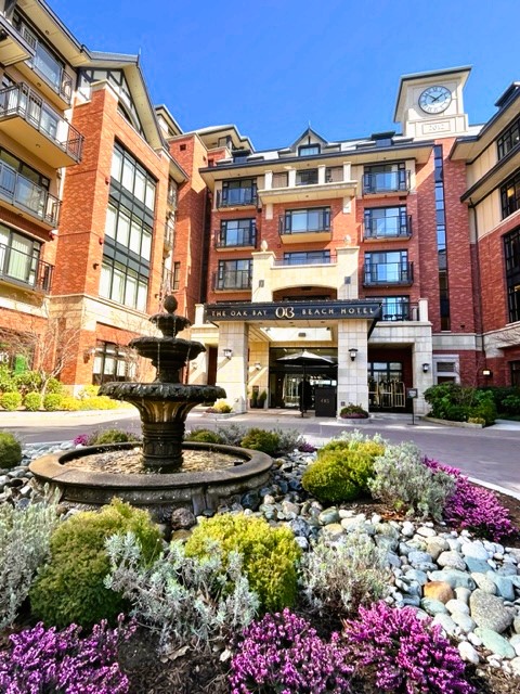 Brick Oak Bay Beach Hotel entrance, with fountain and flowers in front