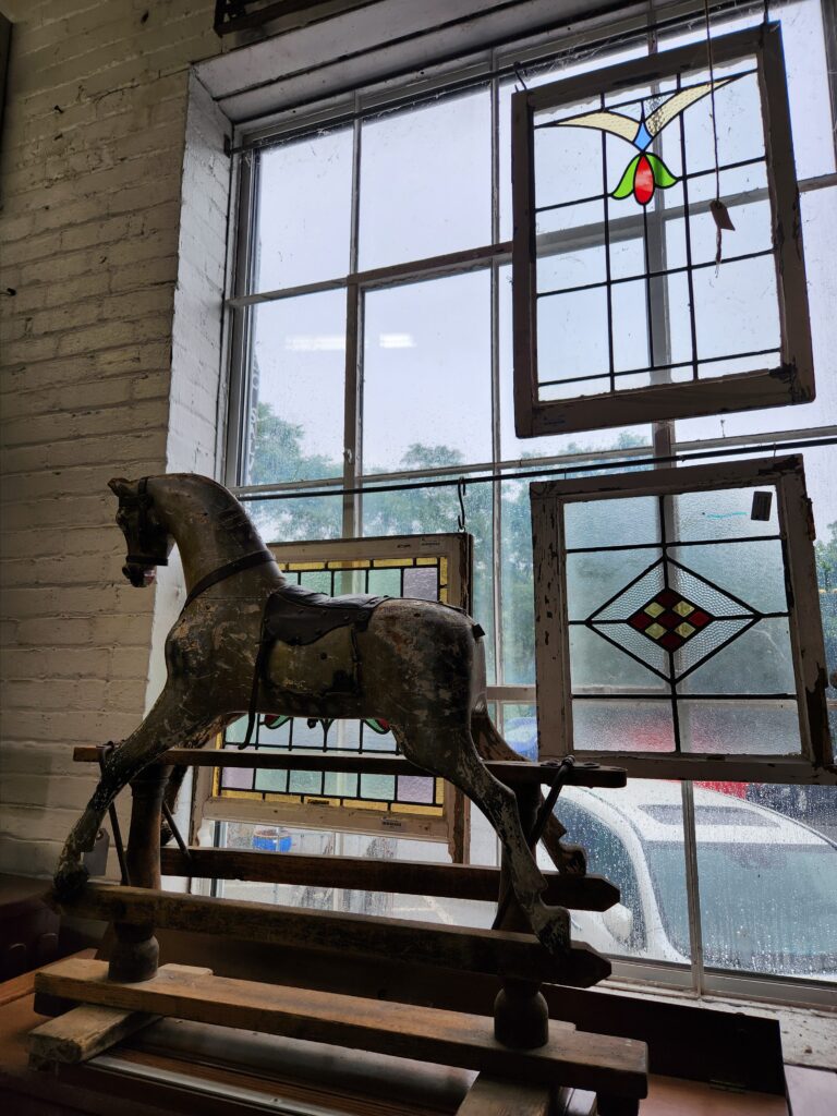 Black Dog Salvage in Roanoke sells stained glass windows salvaged from old homes, and antique toys like the hobby horse shown.