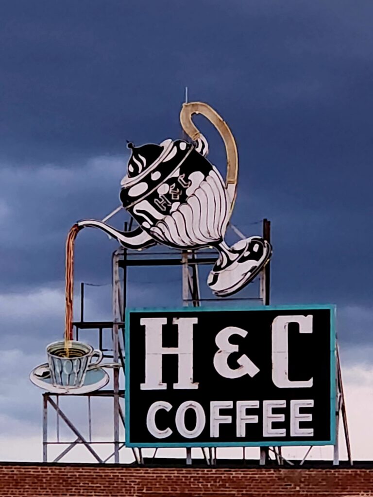 Downtown Roanoke stores, topped with a huge lighted sign of a coffee pot pouring H & C coffee into a cup