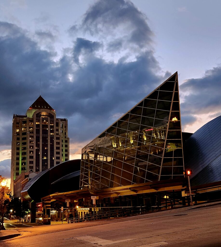 An angular mirrored building at sunset, with views of other Roanoke buildings reflecting in the mirrors.
