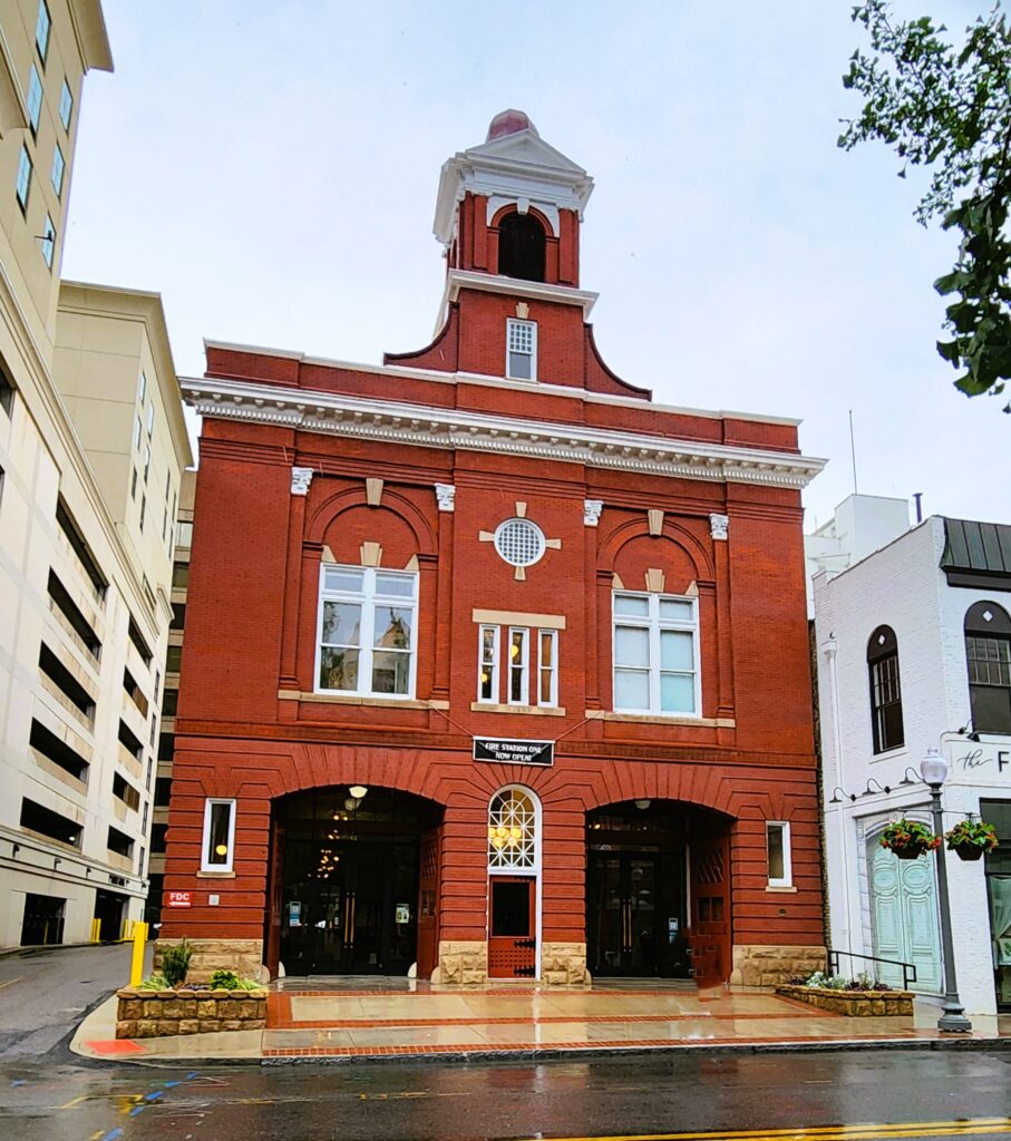 A red brick 1907 fire station with a bell tower on top in downtown Roanoke
