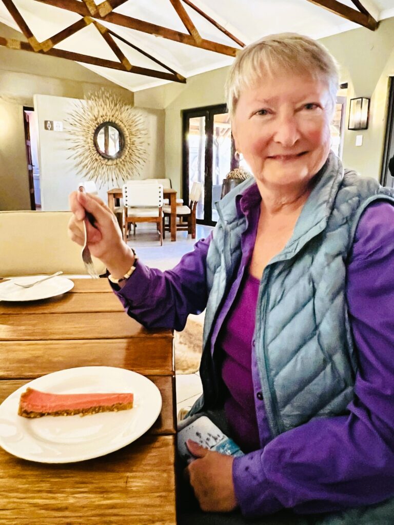 Writer Jo Clark with a fork digging into a slice of pink grapefruit pie