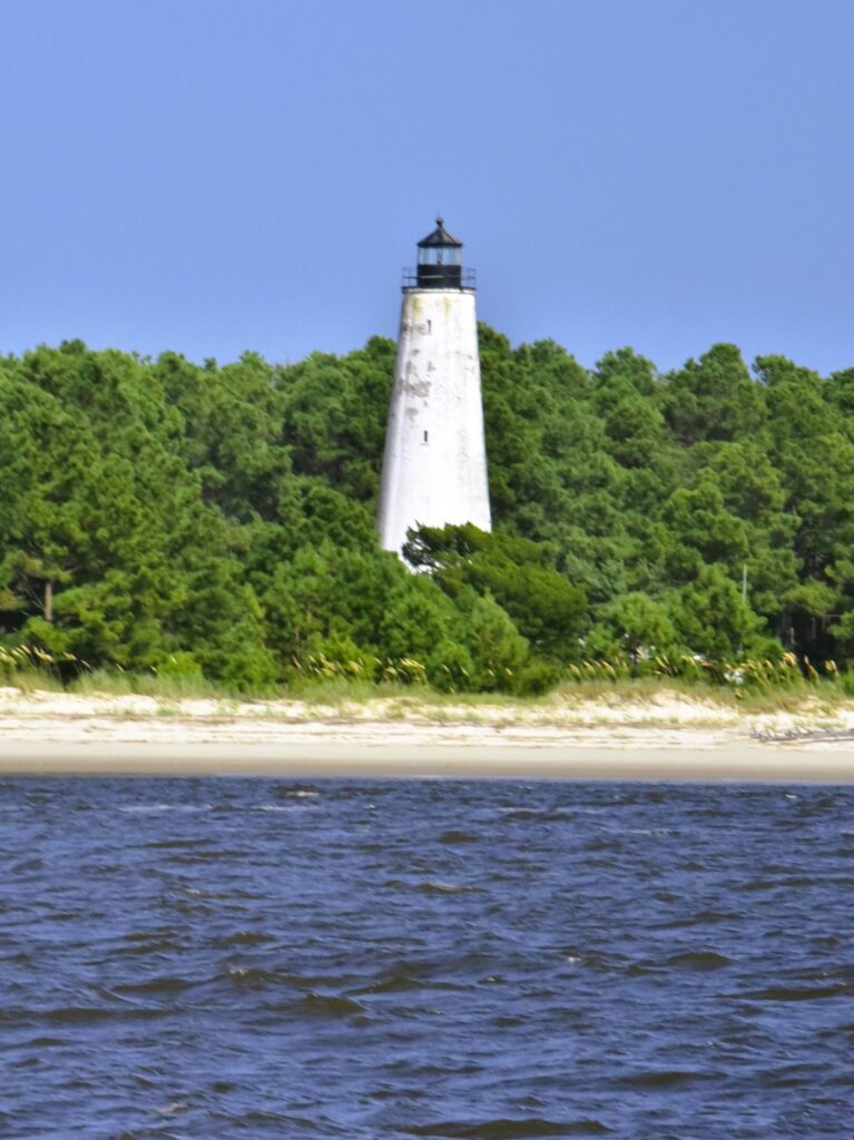 A white brick lighthouse, built in 1811, stands guard at the waterway entrance to Georgetown.