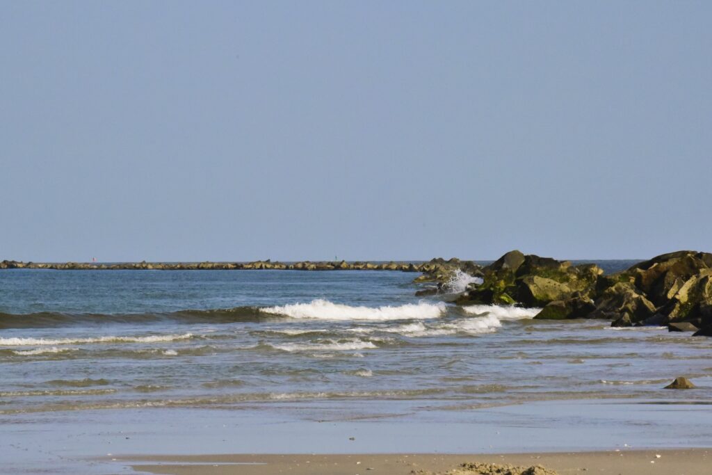 Tall, long rock jetties help control the water flooding the harbor.