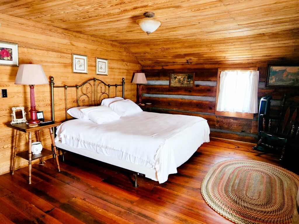 A big bras bed in the upstairs bedroom of the cabin, ready for a good night's sleep.