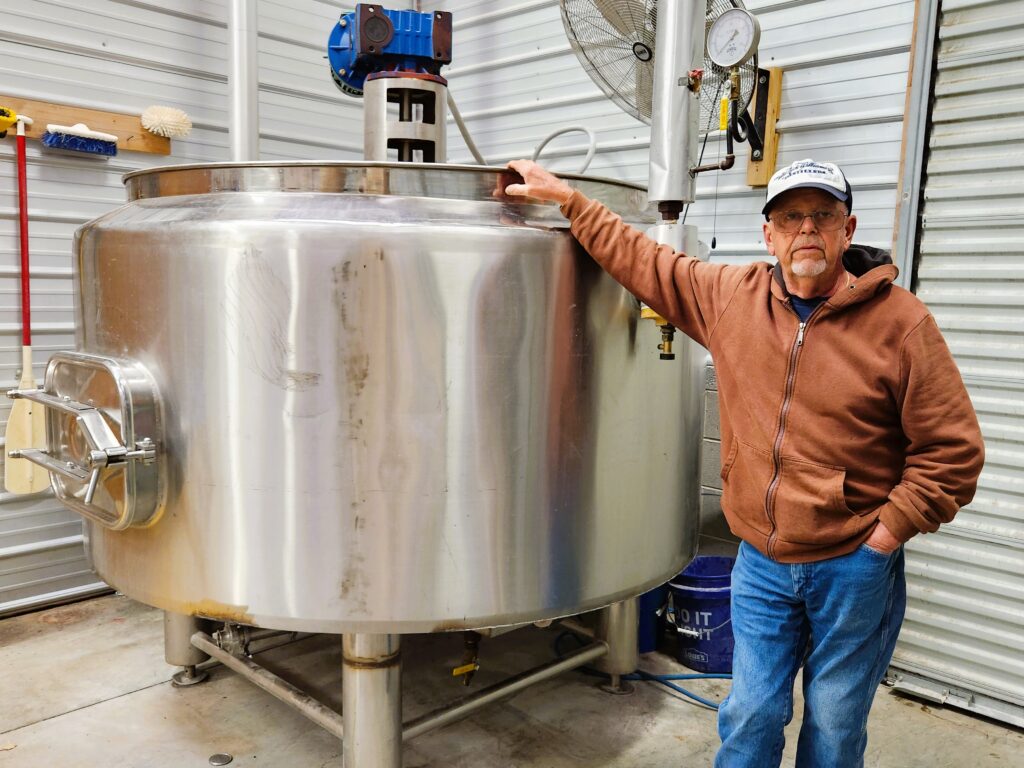Current Williams owner beside the still at Old Nick Williams Distillery.