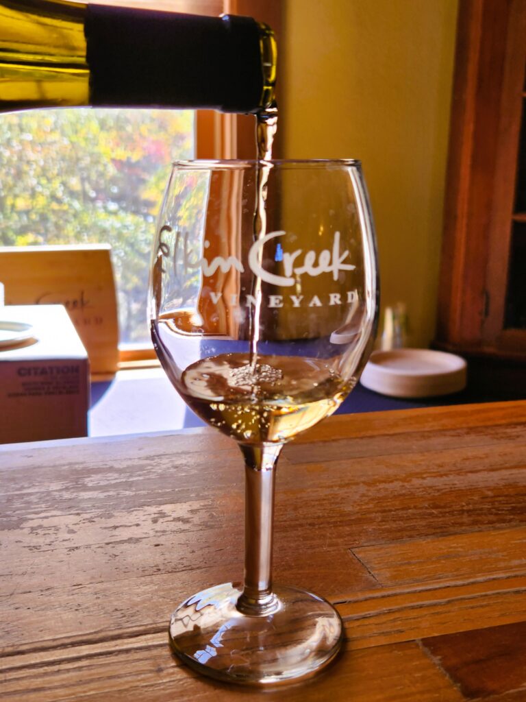 Yadkin Valley wine being poured into an Elkin Creek Vineyard glass for a tasting.