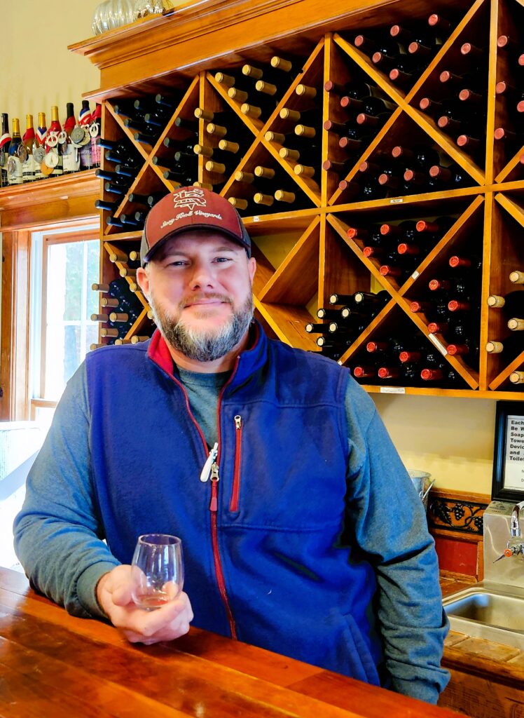 Jonah Hoosier, as he enjoys telling us everything about Stony Knoll winemaking, and shars a glass of wine with us.