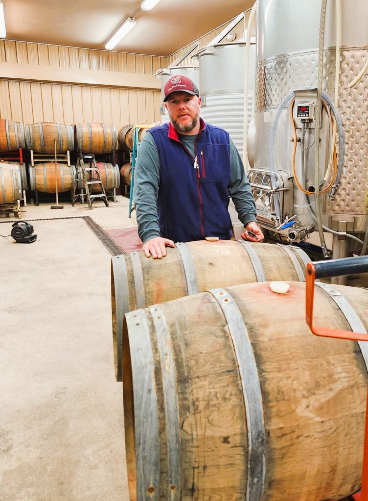 Jonah Hoosier, Yadkin Valley wine owner's son-in-law, as he moves barrels in the barrel room.