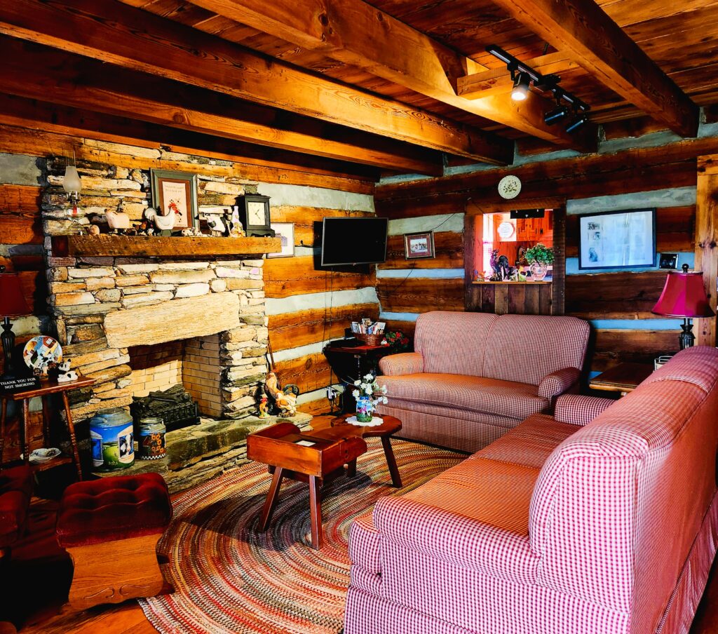 Yadkin Valley wine estate's cabin, available for rental. The Living Room is homey, and the fireplace stands ready for use!