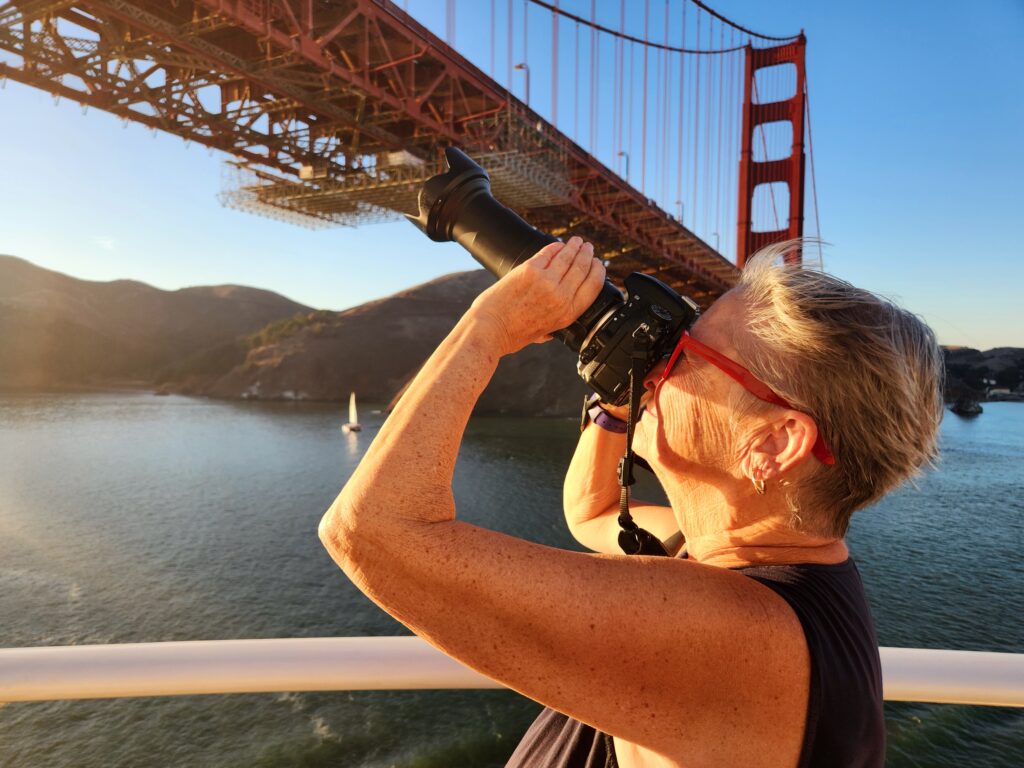 Author taking photo of Golden Gate Bridge as Discovery Princess sails underneath