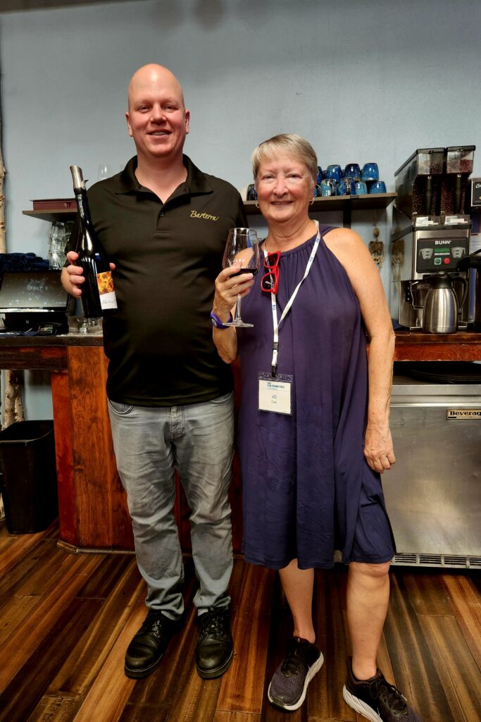 Half Moon Bay's Barterra Wines owner pouring wine for the writer, Jo Clark