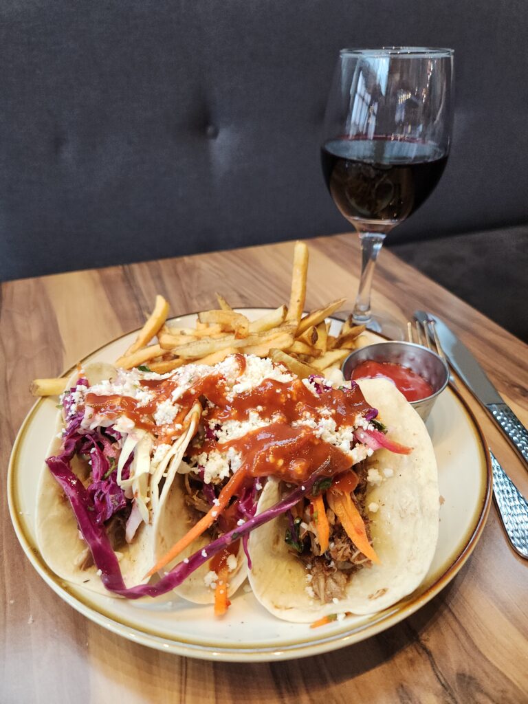 Unique & Vibrant Gwinnett Cities Just 9 Miles From Atlanta 12 Three pulled pork tacos with fries on a plate & glass of red wine