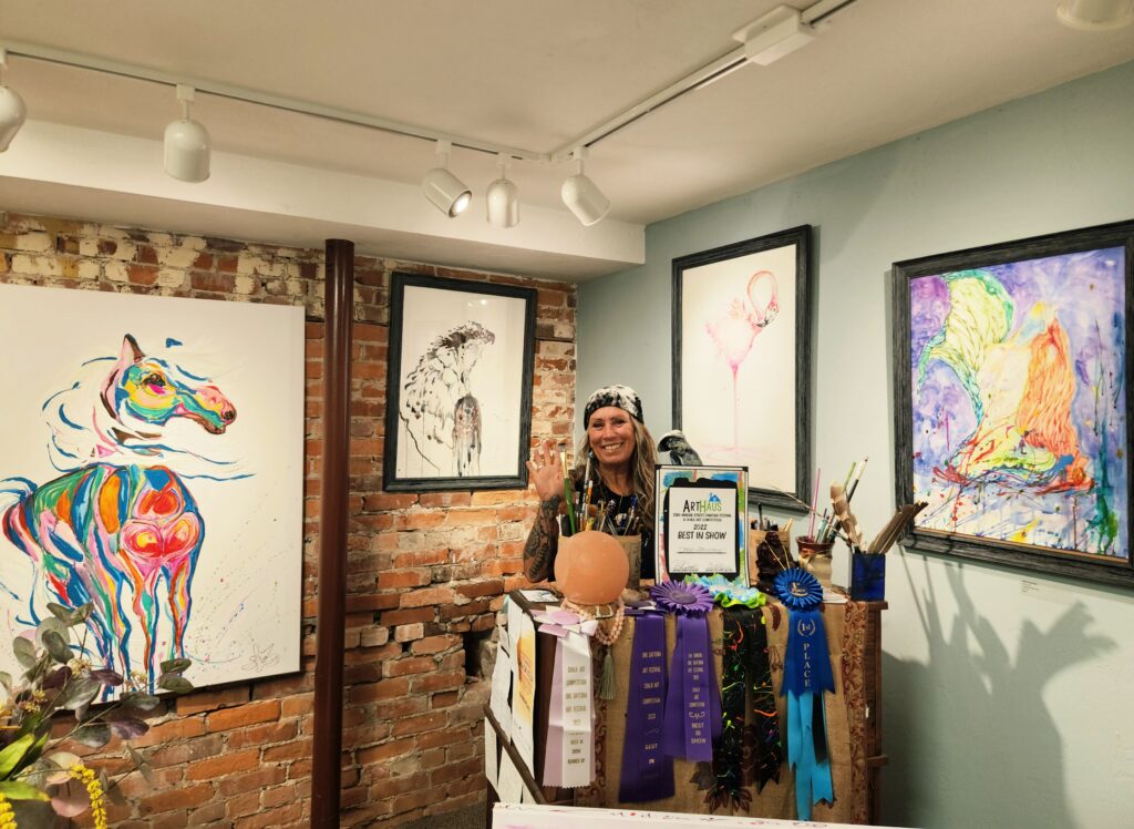 An artist greets visitors in her booth at The Hub.