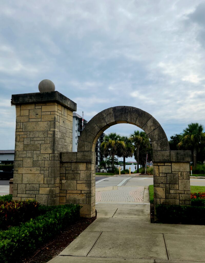 A decorative stone entrance gate and archway to the New Smyrna Beach Canal Street Historic District
