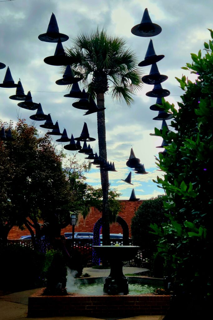 A bubbling, boiling fountain with witches' hats dancing above.