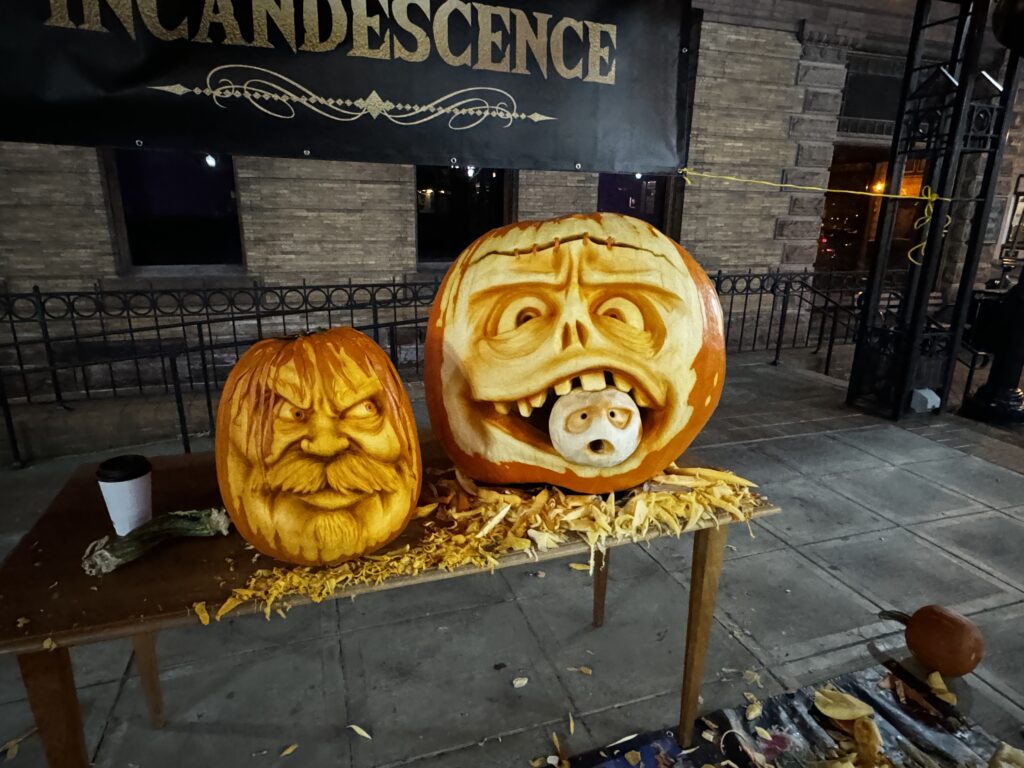Intricately carved pumpkins on a display table in Corning NY.
