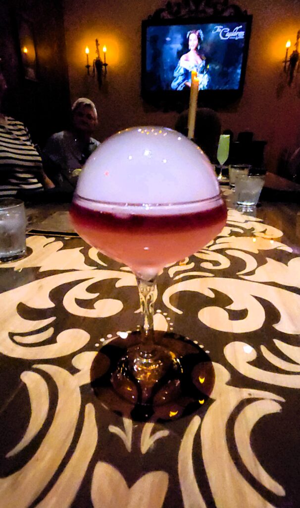A drink with a bubble of smoke on top at the Cauldron in Buena Park's Haunted bar.