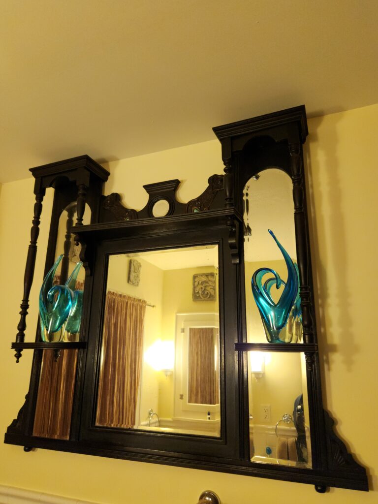 Spend 11 Awesome Days in the Willamette Valley 7 The top of a Victorian dresser hangs in the bathroom, reflecting light.