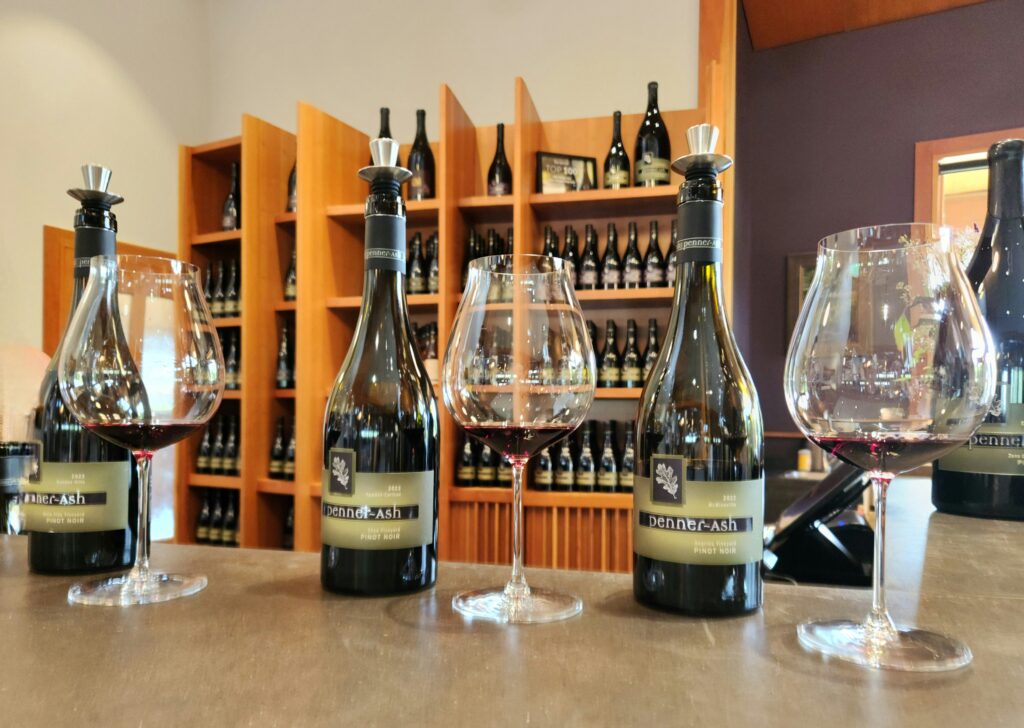 26 Sensational Must-Visit Oregon Wineries in the Willamette Valley 82 A horizontal tasting of Penner-Ash Pinot Noirs, bottles and glasses ready on the tasting counter.