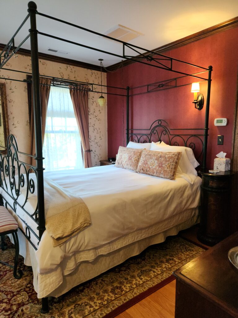 Spend 11 Awesome Days in the Willamette Valley 6 Dark red walls in guestroom with an iron poster bed.