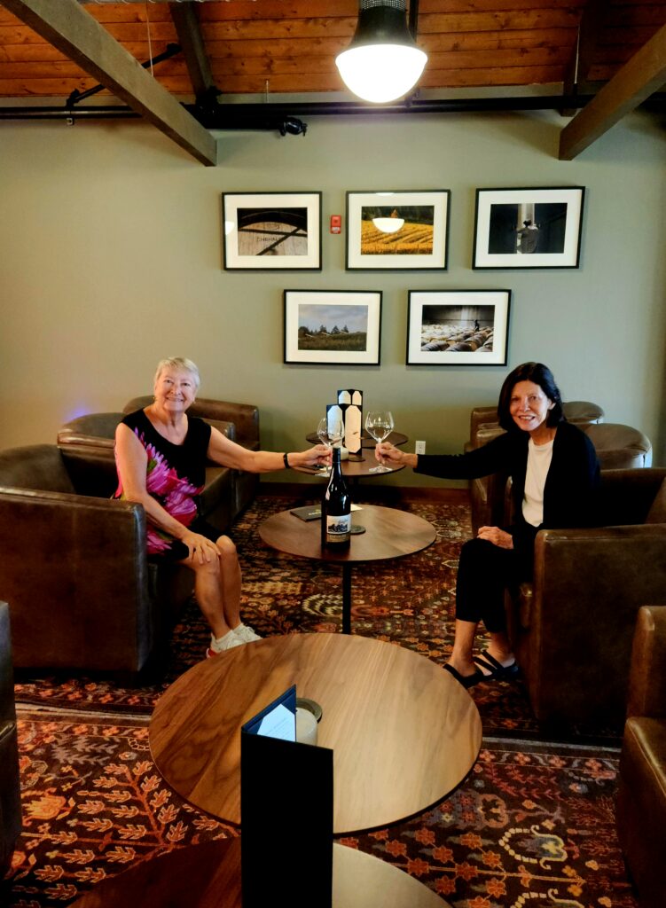 26 Sensational Must-Visit Oregon Wineries in the Willamette Valley 9 Two women toasting in a luxurious lounge at Chehalem Winery.