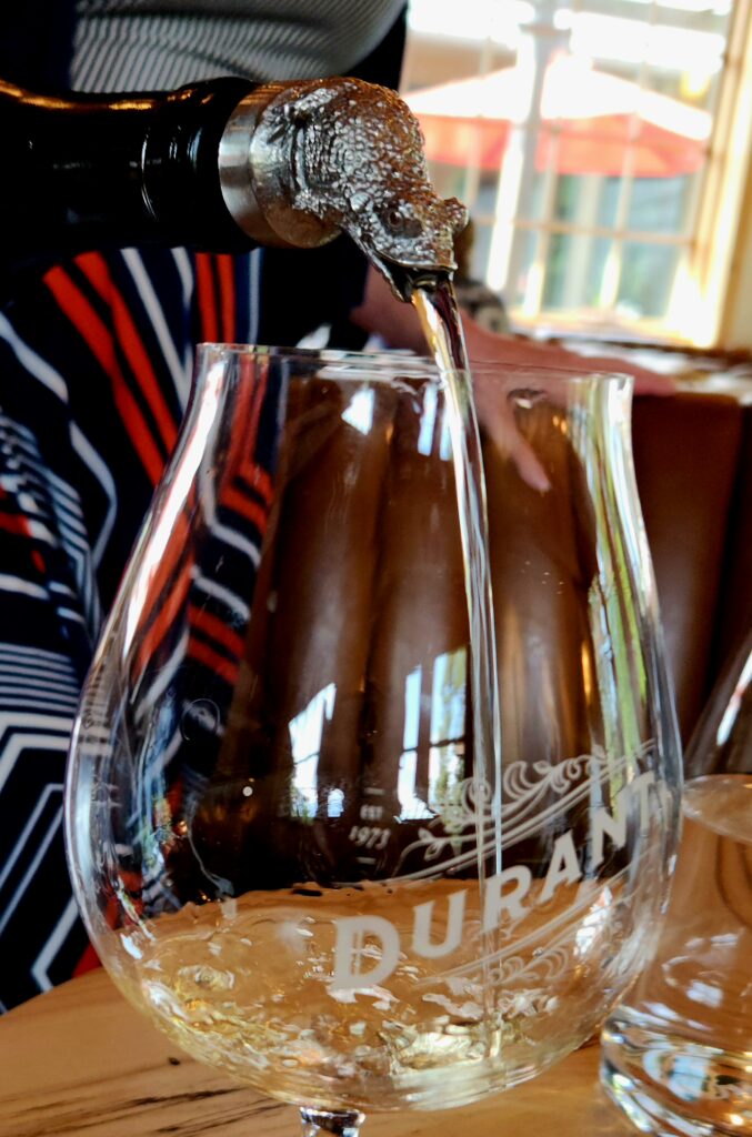 26 Sensational Must-Visit Oregon Wineries in the Willamette Valley 99 A glass being filled with wine.