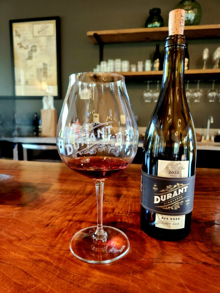 26 Sensational Must-Visit Oregon Wineries in the Willamette Valley 97 A bottle of wine and glass with a sample.