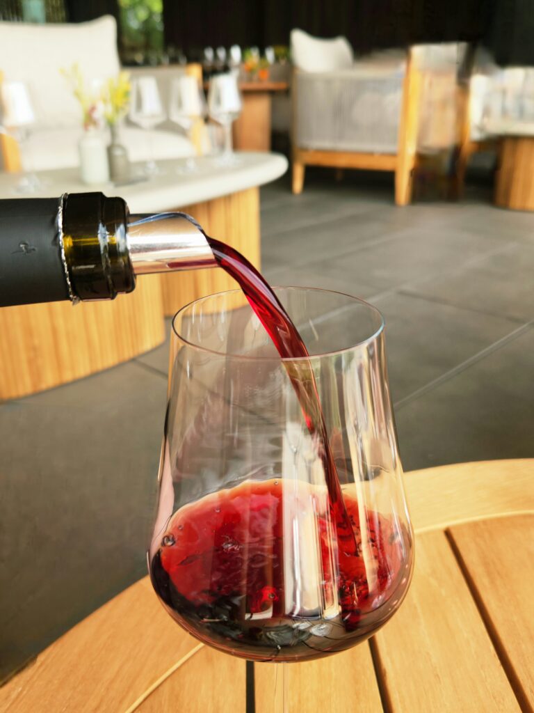 26 Sensational Must-Visit Oregon Wineries in the Willamette Valley 23 Red wine being poured into a wine glass.