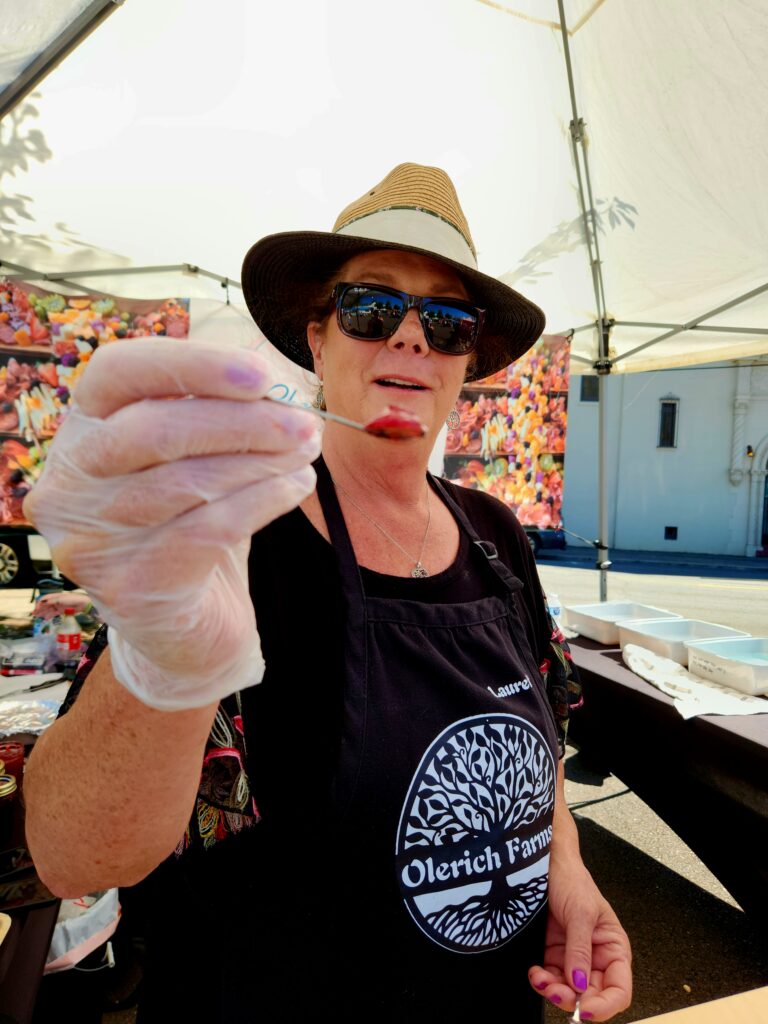 Spend 11 Awesome Days in the Willamette Valley 2 Woman with a spoon giving writer a sample.of jam.