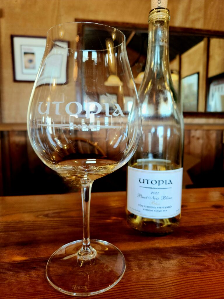 26 Sensational Must-Visit Oregon Wineries in the Willamette Valley 40 A glass of white wine and bottle of the wine.