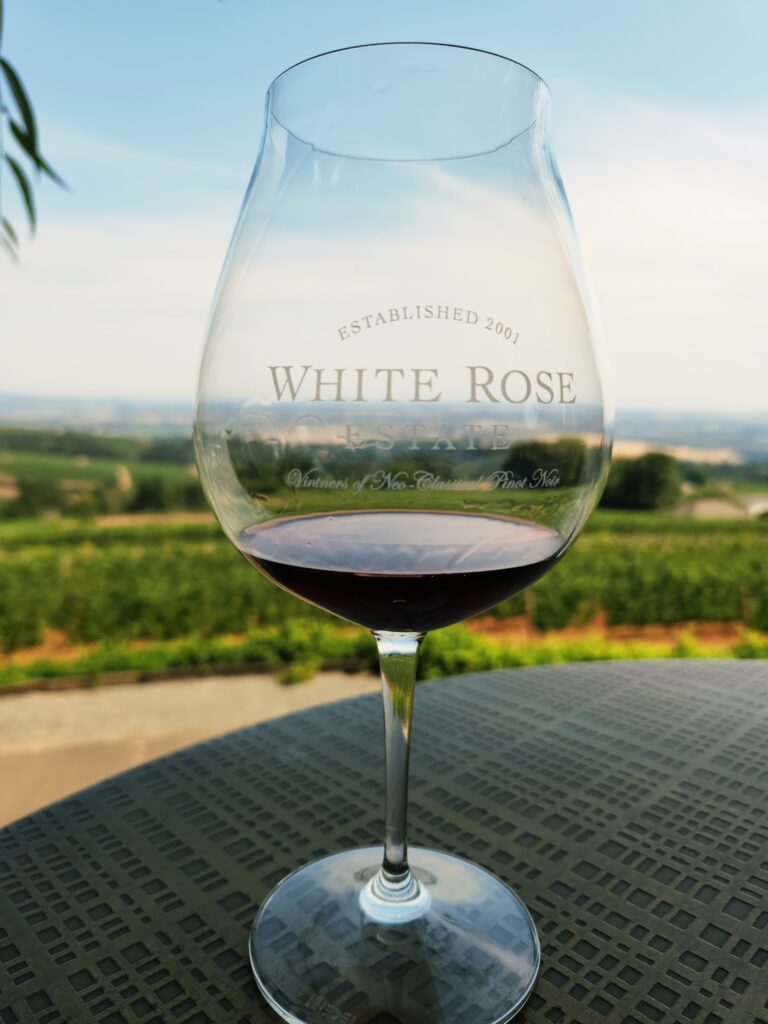 26 Sensational Must-Visit Oregon Wineries in the Willamette Valley 93 Pinot Noir in a White Rose wine glass.