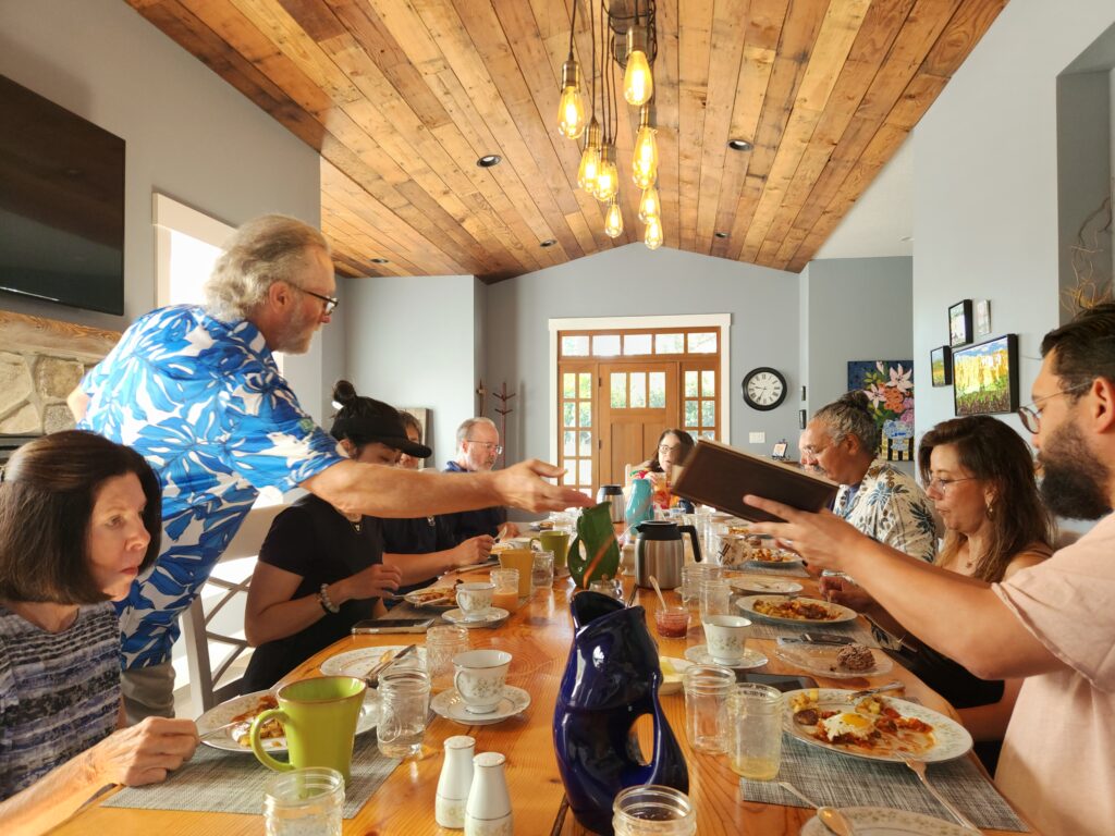 Spend 11 Awesome Days in the Willamette Valley 21 Man handing out plates at breakfast table in the B&B.