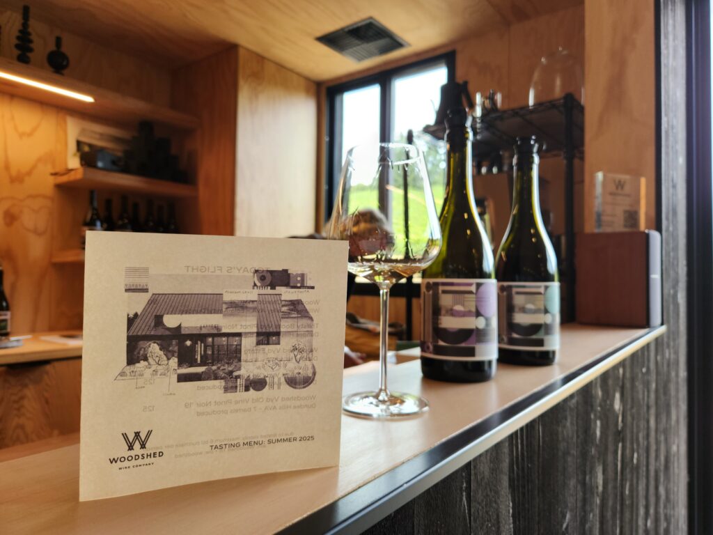 26 Sensational Must-Visit Oregon Wineries in the Willamette Valley 29 Tasting Bar with glass and bottles set up.