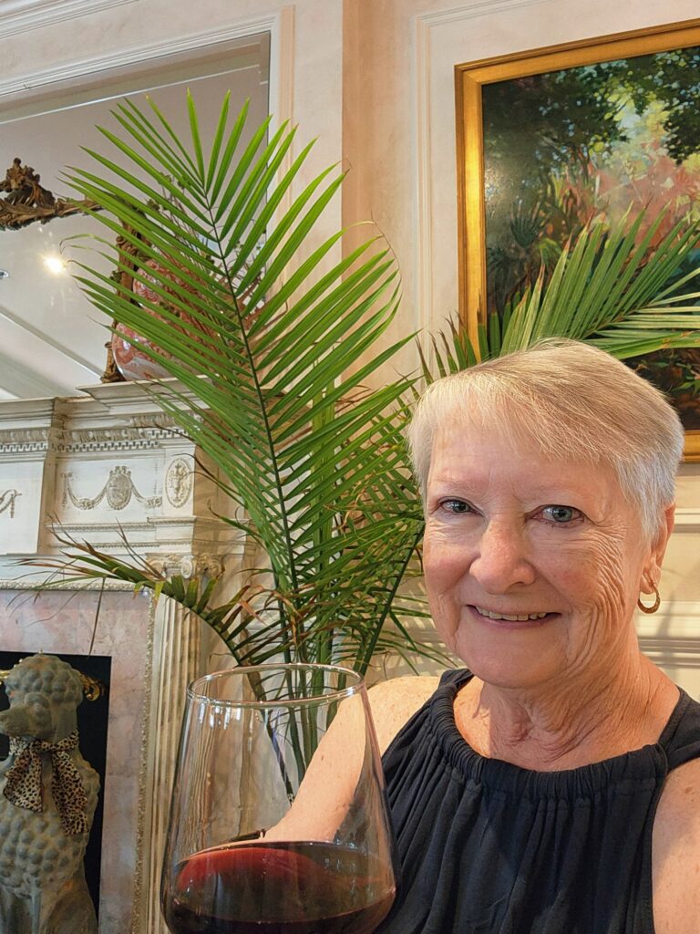2 Islands, a Lighthouse, & Secret Magic of the Lowcountry 51 Jo enjoying a glass of red wine.