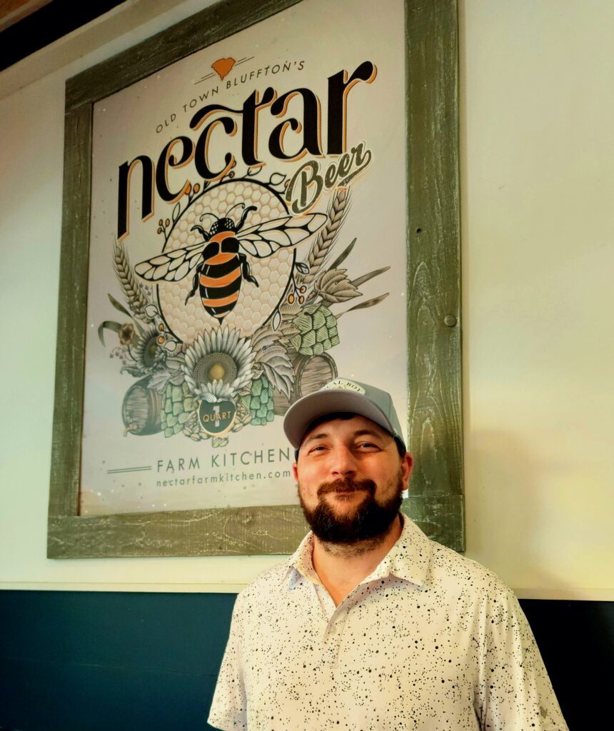2 Islands, a Lighthouse, & Secret Magic of the Lowcountry 68 A chef in front of the Nectar sign.