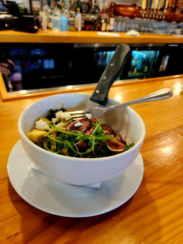 2 Islands, a Lighthouse, & Secret Magic of the Lowcountry 69 A bowl of rice topped with veggies topped with meat.